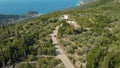 AERIAL: Cars driving along the hairpin turns leading across the scenic island.