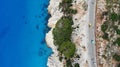 Aerial. Cars driving by the highway near the mediterranean sea. Top view