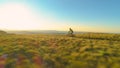 AERIAL: Cinematic shot of downhill biker riding his bicycle in the summer sun. Royalty Free Stock Photo