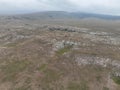 Aerial Cinematic slow motion shot of Drone Flying over a large herd of wild horses galloping fast across the steppe. Royalty Free Stock Photo