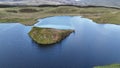 Aerial orbit shot of the island at Llyn Dywarchen in the Eryri National Park, Wales