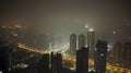 Aerial city landscape at night, misty foggy air and the street full of light Royalty Free Stock Photo