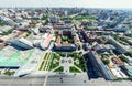 Aerial city view with crossroads and roads, houses, buildings, parks and parking lots. Sunny summer panoramic image