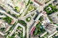 Aerial city view with crossroads and roads, houses, buildings, parks and parking lots. Sunny summer panoramic image Royalty Free Stock Photo