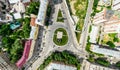 Aerial city view with crossroads and roads, houses, buildings, parks and parking lots. Sunny summer panoramic image Royalty Free Stock Photo