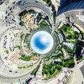 Aerial city view with crossroads and roads, houses, buildings, parks and parking lots. Sunny summer panoramic image