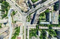 Aerial city view with crossroads and roads, houses, buildings, parks and parking lots. Sunny summer panoramic image Royalty Free Stock Photo