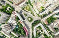 Aerial city view with crossroads and roads, houses, buildings, parks and parking lots. Sunny summer panoramic image Royalty Free Stock Photo