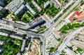 Aerial city view with crossroads and roads, houses, buildings, parks and parking lots. Sunny summer panoramic image Royalty Free Stock Photo