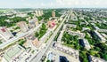 Aerial city view with crossroads and roads, houses, buildings, parks and parking lots. Sunny summer panoramic image Royalty Free Stock Photo