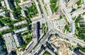 Aerial city view with crossroads and roads, houses, buildings, parks and parking lots. Sunny summer panoramic image Royalty Free Stock Photo