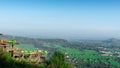 Aerial city view from a hill in the morning with a blue sky background