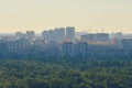 Aerial cityscape of Kyiv in morning haze. Silhouettes of modern high-rise buildings at smog