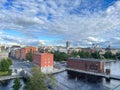 Aerial of a cityscape of Tampere in Finland, drone shot of city buildings under scattered clouds