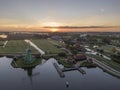 Aerial of classic dutch windmills at the Zaanse Schans during a stunning sunrise Royalty Free Stock Photo