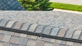 Aerial close up of roof anchor ring on roof with brown and gray shingles