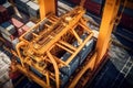 Aerial close up view of a cargo container ship at the pier of cargo seaport. Port cranes stack containers onboard a