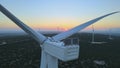 Aerial close up of wind turbine windmill blades at sunset. Renewable energy Royalty Free Stock Photo