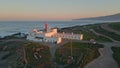 Aerial coastal beacon standing rocky seashore at summer sunset. Beautiful sky Royalty Free Stock Photo