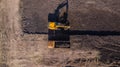 Aerial construction - top down view of an excavator and truck working on a construction site