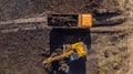 Aerial construction - top down view of an excavator and truck working on a construction site