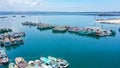 Aerial container terminal of Benoa Harbour with stacks of the boxes and a red command tower under light blue sky Royalty Free Stock Photo