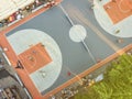Aerial directly above view of street basketball court competition with the people playing