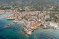 Aerial done shot of Komiza town coastline on Vis Island in Croatia before sunrise in morning