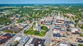 Aerial downtown Columbia City with courthouse and shops with distant houses