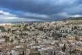 Aerial dramatic panoramic view of the old city in Granada, Spain, located at foot of Sierra Nevada Mountains. European cityscape. Royalty Free Stock Photo