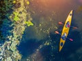 Aerial drone bird`s eye view photo of two kids enjoying kayak ride on beautiful river. Little boy and teenager girl Royalty Free Stock Photo