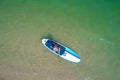 Aerial drone birds eye view of young woman exercising sup board in turquoise tropical clear waters Royalty Free Stock Photo