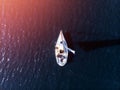 Aerial drone expensive yacht with white sail on blue water of sea Royalty Free Stock Photo