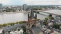 Aerial drone footage of Cologne Cathedral along the shore of the Rhine River in Germany.