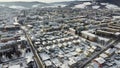 Aerial drone footage flying overlooking housing estates, public parks and commercial properties in a built up area in