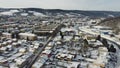 Aerial drone footage flying overlooking housing estates, public parks and commercial properties in a built up area in