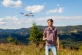 Aerial drone footage shooting of summer Carpathins. Man operating copter controller in mountains. Tourist filming nature Royalty Free Stock Photo