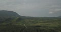 Aerial drone footage of a tropical landscape, with forest and mountains Kumbira forest reserve, small village and huge geologic