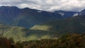 Aerial Drone Footage View: Flight over autumn mountain village with forests, fields and river in sunrise soft light Royalty Free Stock Photo