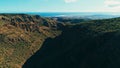 aerial drone image of beautiful stunning landscape cliffs and valleys and Maspalomas and playa ingles in the background on a sunny