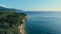 Aerial drone image of a remote south pacific island with sandy beach shore and beautiful ocean sea seascape and lush tropical Royalty Free Stock Photo