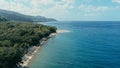 Aerial drone image of a remote south pacific island with sandy beach shore and beautiful ocean sea seascape and lush tropical Royalty Free Stock Photo