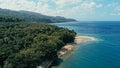 Aerial drone image of a remote south pacific island with sandy beach shore and beautiful ocean sea seascape and lush tropical Royalty Free Stock Photo