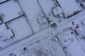 Aerial drone image of the roof of a suburban house during winter. Roof and surrounding area is covered with snow Royalty Free Stock Photo