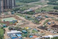 Aerial drone image top view of a construction site. Heavy equipment is grading the land, moving and flattening out red clay soil Royalty Free Stock Photo