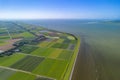 Aerial drone image of typical Dutch farmland, polder, near lake and windmills Royalty Free Stock Photo