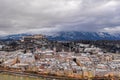 Aerial drone overview of Salzburg old town skyline covered with snow and view of Hohensalzburg in Austria winter