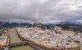 Aerial drone overview of Salzburg old town skyline covered with snow and view of Hohensalzburg in Austria winter