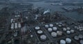 Aerial drone overview view on refinery in the port of Antwerp. Processing of fossil fuels. Petroleum industry at dusk