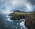 Aerial drone panorama of Gasadalur village and Mulafossur its iconic waterfall, Vagar, Faroe Islands, Denmark. Rough see